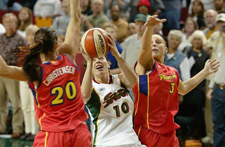 Sue Bird guarded by Christensen and Taurasi