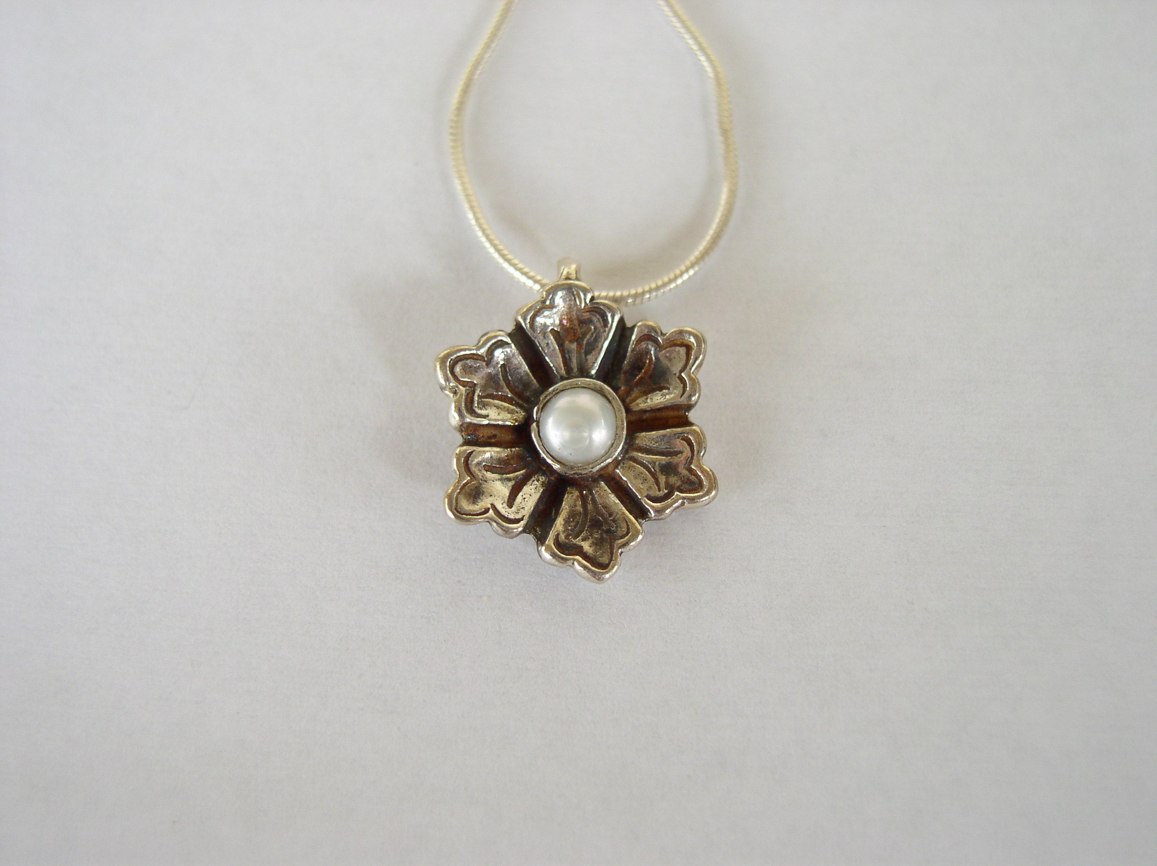 silver flower pendant with pearl