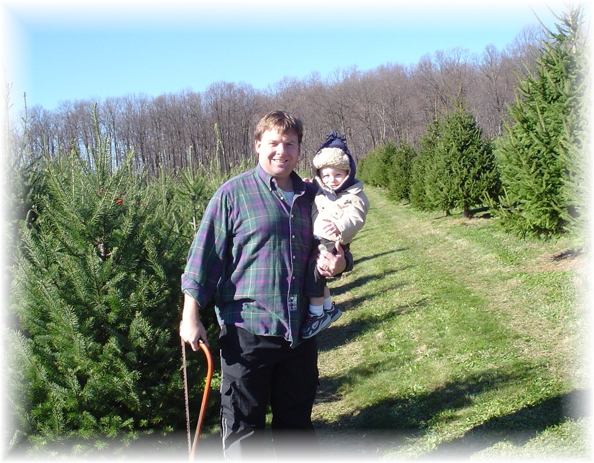 Daddy and Aidan searching for a tree to cut down