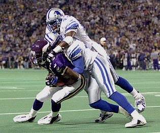 Minnesota Vikings - Cris Carter and Randy Moss on the sidelines during a  game in 1999.