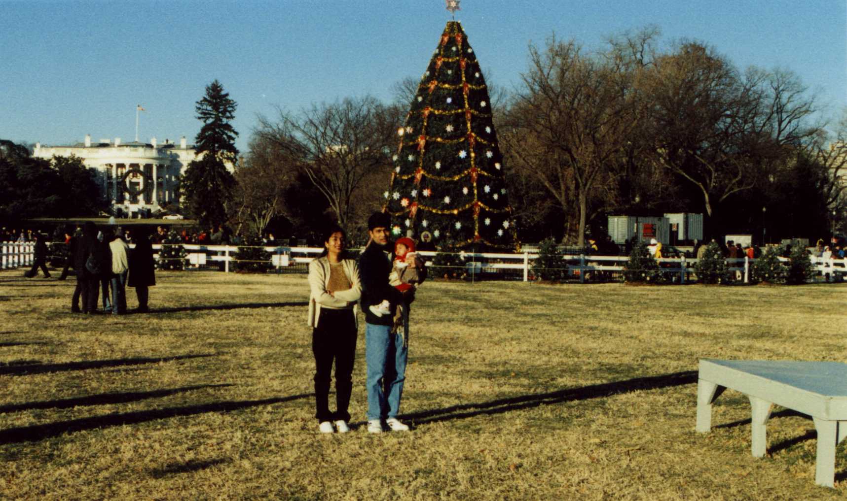 In front of huge  Christmas tree